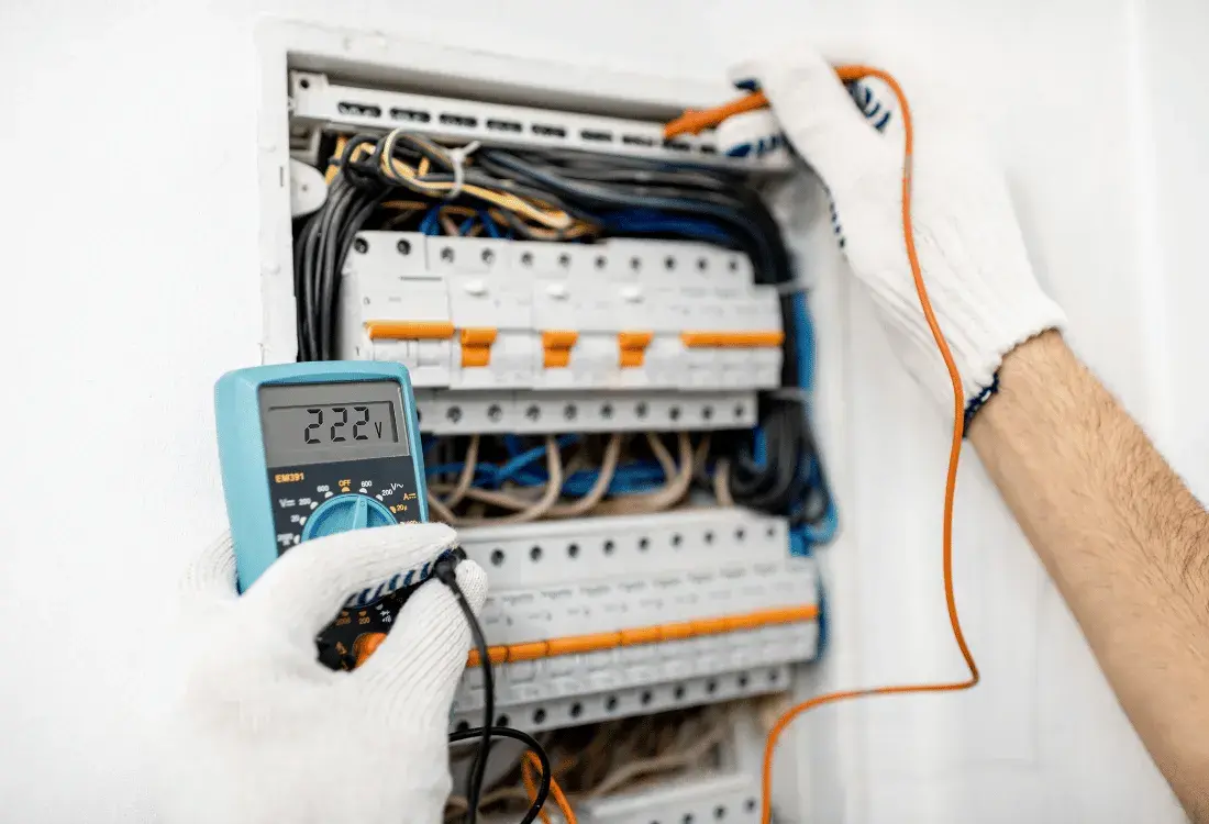 An electrical panel being tested to show the steps to take to have a safe and compliant electrical system in your business.